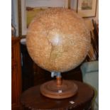 A vintage table world globe, with swivel mechanism, raised on circular wood stand,