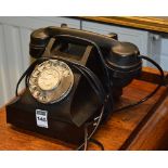 A vintage black Bakelite telephone,