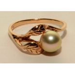 A 10ct gold pearl ring, the central white pearl within leaf motif setting, stamped 10k to underside,