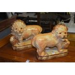 A pair of Boness pottery lion figures, both with amber glass eyes,