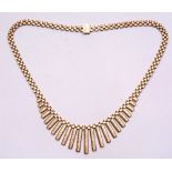 A 9ct gold necklace, of brick link formation with graduated bar drops, stamped 375 to clasp, 33g,