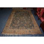 An Eastern carpet, the allover cream diamond motifs over blue ground,