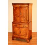 A walnut cocktail cabinet, with two panelled doors above mirrored slide and two drawers,