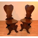 A pair of George III mahogany hall chairs,