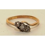 An 18ct gold and platinum three stone diamond ring,