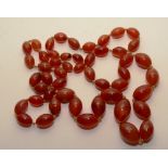 A string of graduated cornelian beads,