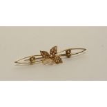 A 15ct gold and seed pearl brooch, the 24 seed pearls set within leaf decoration, 5cm long,