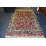 A Hamadan floor rug, with six rows of three geometric motifs on red ground,