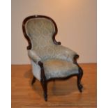 A Victorian mahogany framed and buttonback armchair, upholstered in later green floral velour,