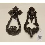 A Victorian metal door knocker, decorated with rams head terminal,