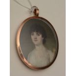 An English portrait miniature circa 1800 of a lady, wearing a white dress,