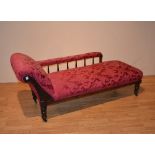 A late Victorian mahogany chaise longue, upholstered in later red floral fabric,