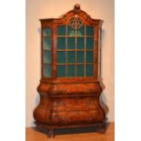 A reproduction Dutch style walnut bookcase on bombe chest,