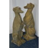 A pair of garden composition dog figures, in the form of seated greyhounds,