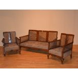 A vintage walnut three piece bergere suite, comprising of settee with pair of armchairs,