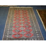 A Hamadan floor rug, with nine rows of two diamond lozenge' on red ground,