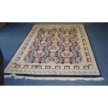 A Persian style floor rug, with multiple floral motifs on blue ground, with cream foliate border,