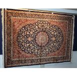 A Kashan carpet, with floral motifs on blue ground,