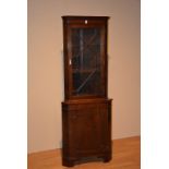 A reproduction mahogany corner cabinet,