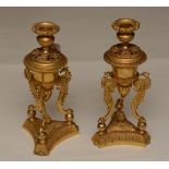 A pair of 19th century ormolu candlesticks, raised on bird terminal supports and platform base,