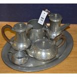 An English hammered pewter four piece tea set by Homeland, comprising of tea pot, coffee pot,