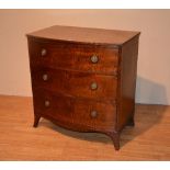 A Regency mahogany bow front chest of drawers, with three drawers, raised on bracket supports,