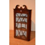 A George III mahogany corner cabinet,