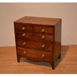 A George III mahogany chest of drawers, of small form with two small drawers,