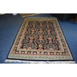 A Persian Hamadan carpet, decorated with multiple floral motfis on blue ground, geometric border,