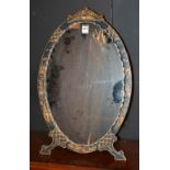 A Chinoisserie oval dressing mirror, decorated with gilt birds in foliage on green ground,