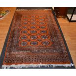 A Persian style rug, decorated with seven rows of three gulls on orange ground,