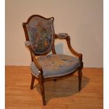 A late 19th century oak French style open armchair,