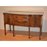 An Edwardian mahogany inlaid serpentine sideboard, with small drawer above deep drawer,