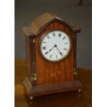 An Edwardian mahogany mantel clock, of lancet form with white enamel dial and Roman numerals,