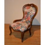 A Victorian style nursing chair, upholstered in floral fabric, serpentine front,
