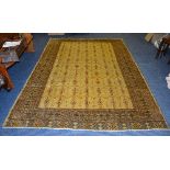 A Turkman carpet, the yellow ground with allover brown geometric patterns,