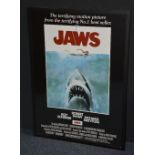 A reproduction movie poster of 'Jaws', in black slip,