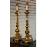 A pair of 19th century tall brass candlesticks, with turned columns, terminating on circular foot,