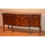 A good reproduction mahogany serpentine sideboard, with single drawer flanked by a small drawer,