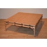 A light wood coffee table, of square form,