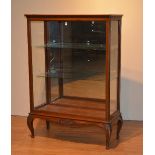 An Edwardian mahogany shop display cabinet, with glazed panels enclosing glass shelves,