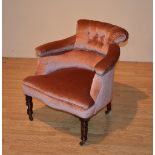 A Victorian upholstered nursing chair, upholstered in later pink velour, raised on turned supports,