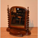A Victorian mahogany dressing mirror, raised on spiral twist column supports,