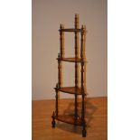 A Victorian mahogany and satinwood inlaid what-not, with three open tiers,