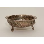 A silver bowl, with hallmarks for London 1876-1877, decorated with embossed floral panels,