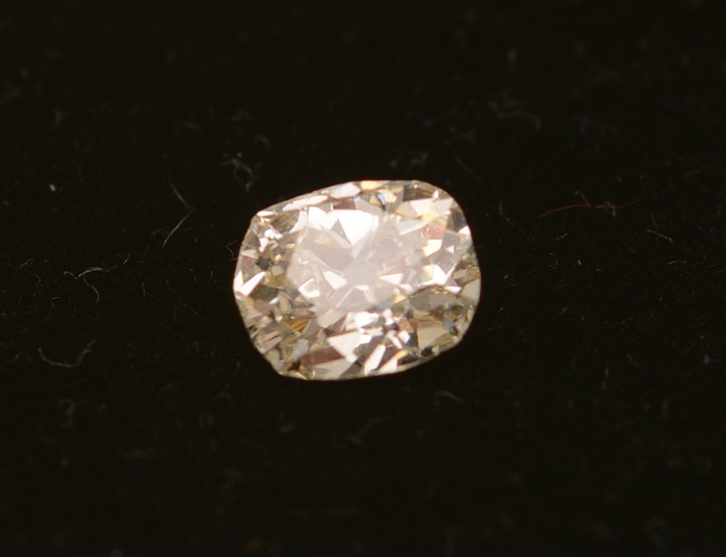 A loose cushion shaped old cut diamond, weighing approximately 1.18ct, clear to the naked eye, 7.