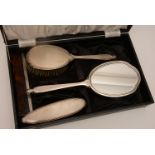 A silver backed four piece dressing table/brush set,