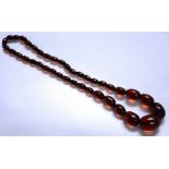 A cherry amber necklace, with graduated faceted beads,