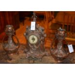 A copper garniture mantel clock, with white enamel dial and Arabic numerals,