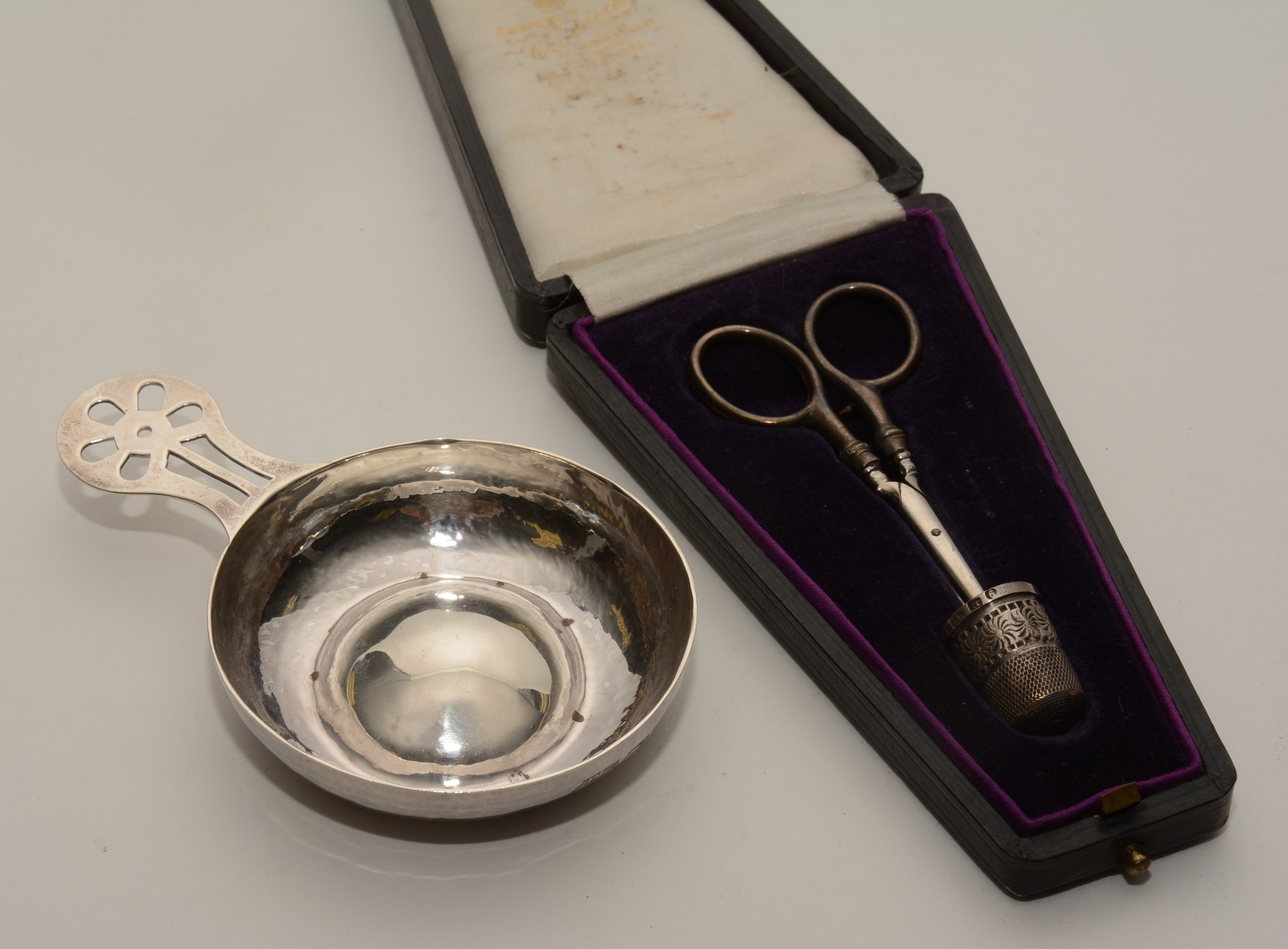 A silver wine taster, hallmarks for London 1970, together with a cased sewing set,